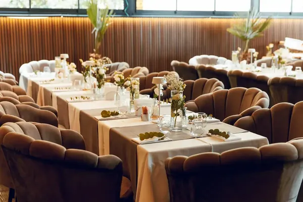 Long banquet tables prepared for an event on the restaurant terrace